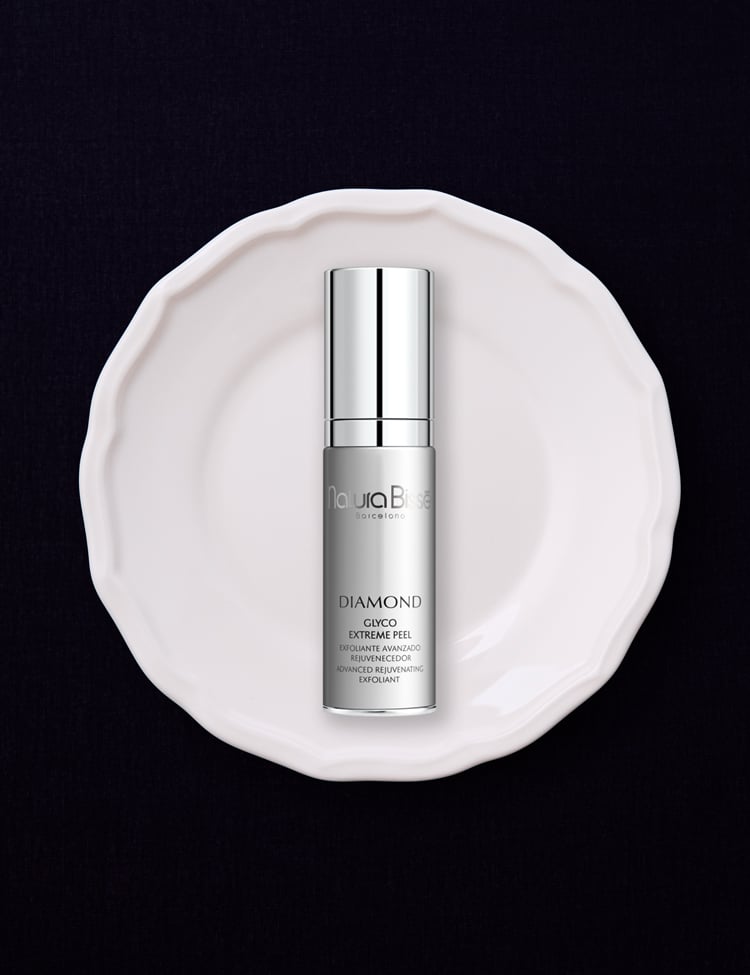 Hand holding Natura Bissé's Diamond Glyco Extreme Peel. Skincare product featured in bestsellers.