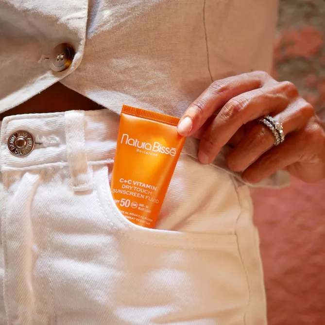 Diamond Luminous SPF on the pocket of a white pair of jeans