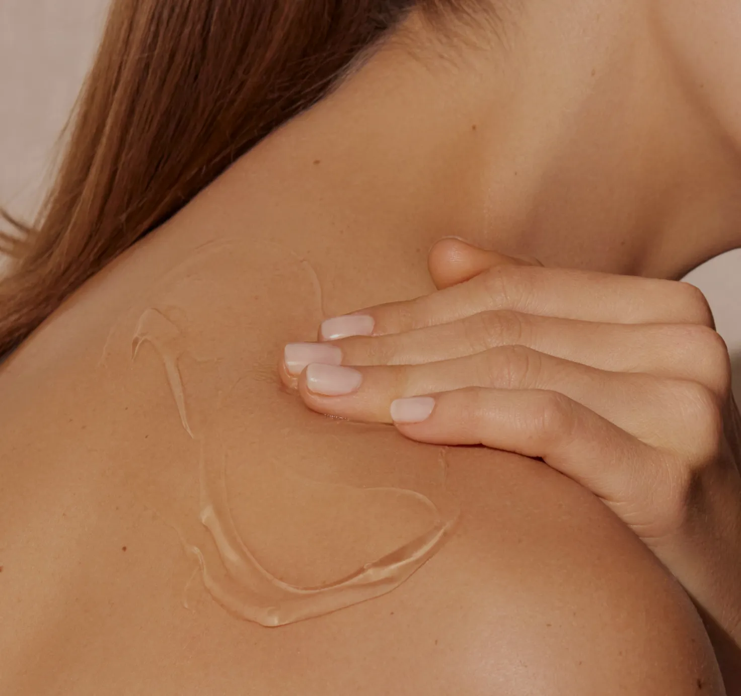 Woman massages her shoulder