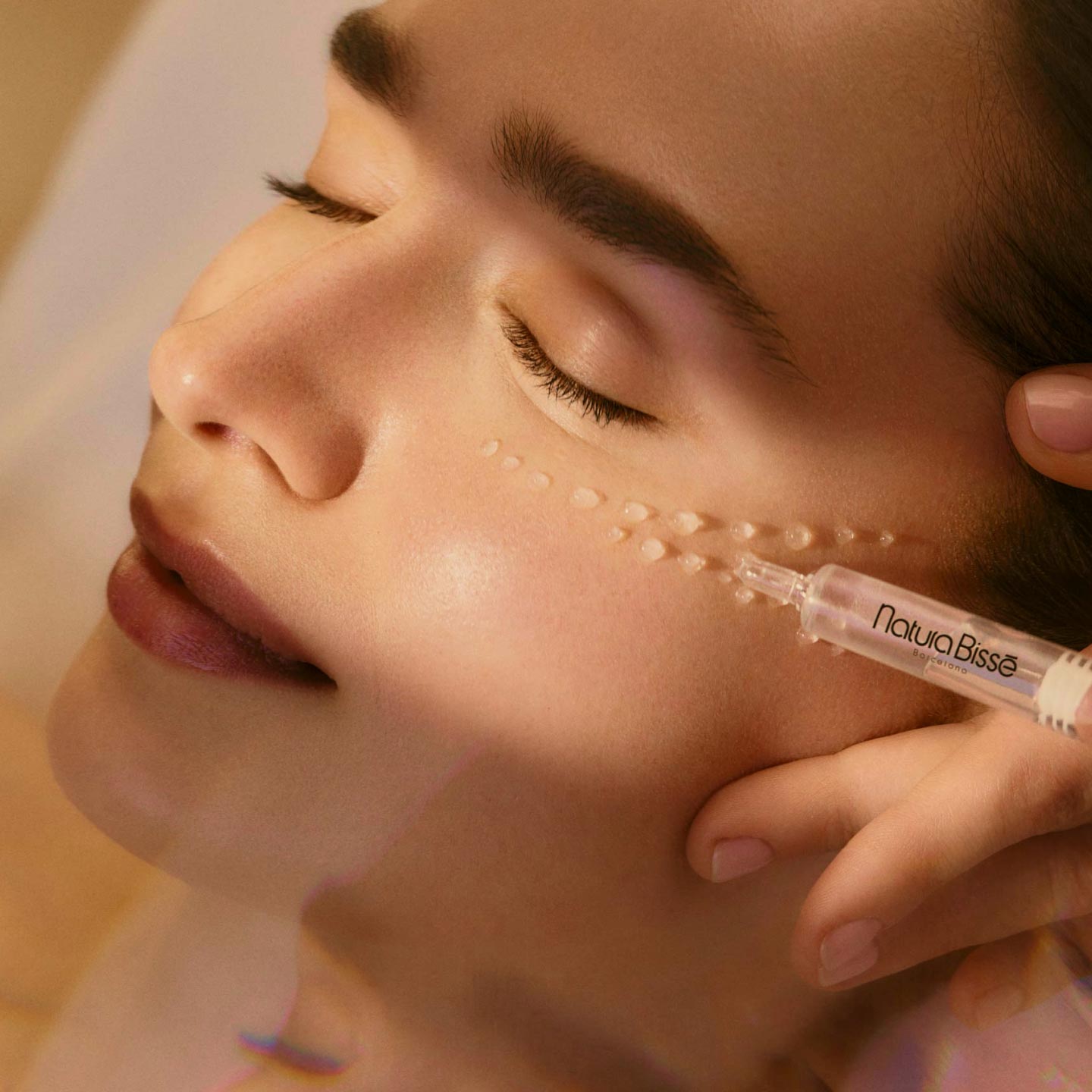 Model enjoying a facial treatment