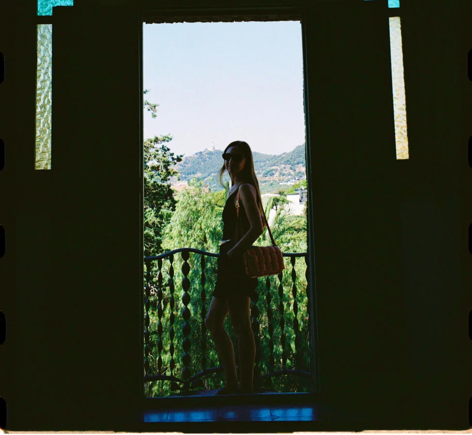 Valeria standing in front of a window inside the Bellesguard Tower building