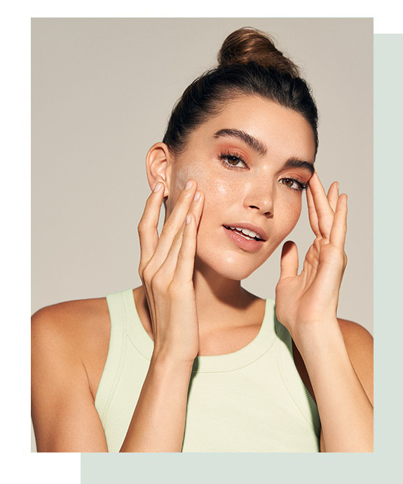 Woman applying facial cleanser