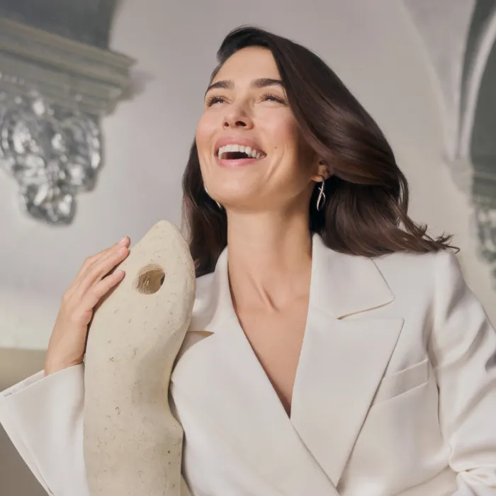 Smiling brunette woman with long hair looks at the horizon