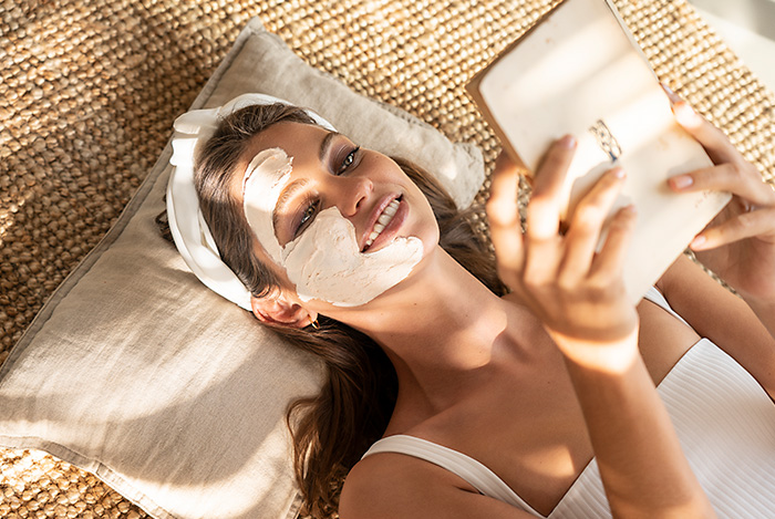 Woman relaxing with cleansing face mask
