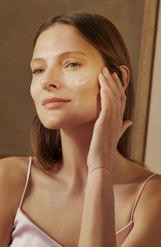 Model applying moisturising cream